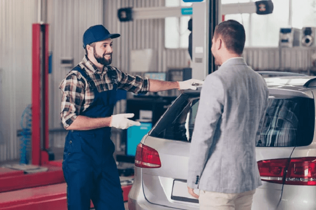 a man talking with a mechanic